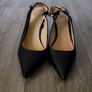 These shoes are black with a gold chain at the back